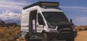 white and black van on brown soil during daytime